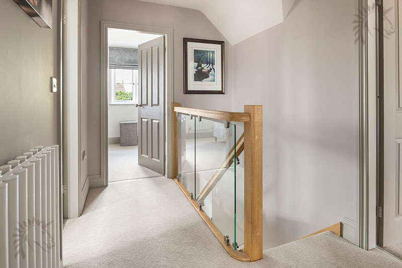 Glass landing panels with Oak handrail and Brackets