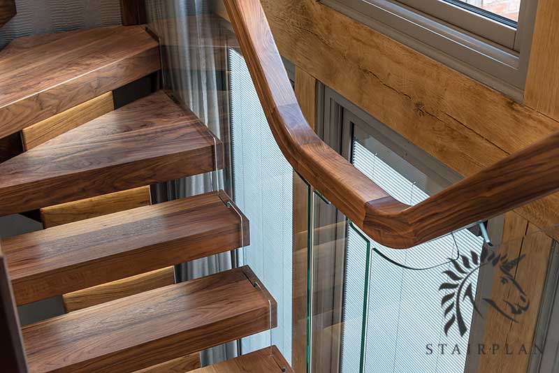 Walnut staircases with embedded glass up easings on handrail